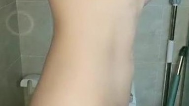 Cute twin sisters masturbating on a bathroom toilet, taking turns fingering themselves and using dildos