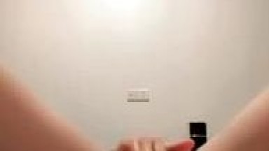 College freshman with shoulder-length hair goes wild on a revealing live stream before school starts to make money. She wears black stockings and teases viewers as instructed, including playing with her breasts. Watch online UAA video.